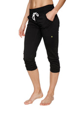 Women’s solid black cuffed jogger yoga pants with white drawstring waistband and side pockets in capri length