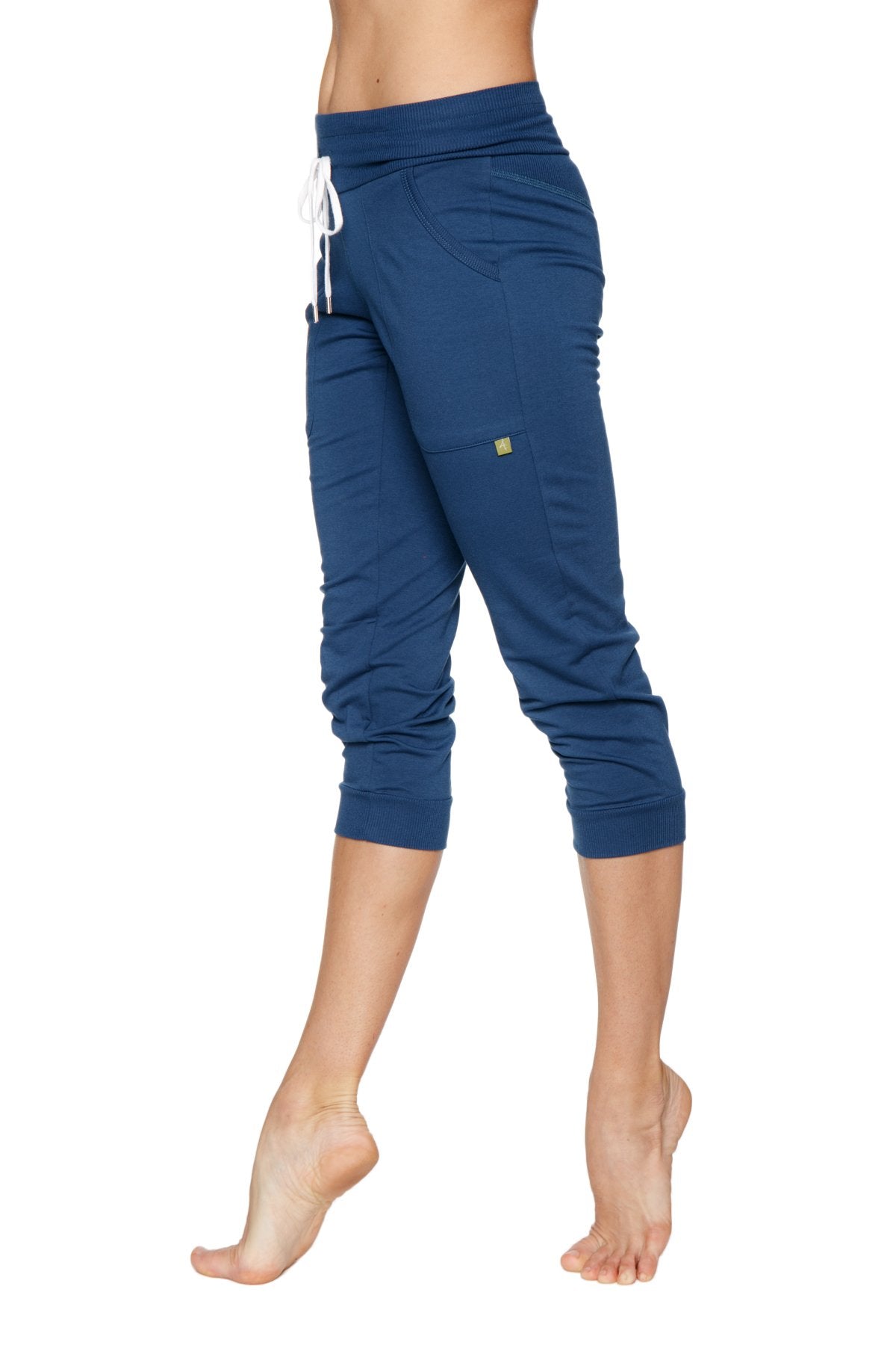 Women’s cuffed jogger yoga pant in solid royal blue with white drawstring waistband and side pockets in navy blue stretchy fabric