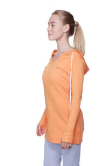 Orange women’s long body hoodie top with white zipper trim and long sleeves in solid sun orange color