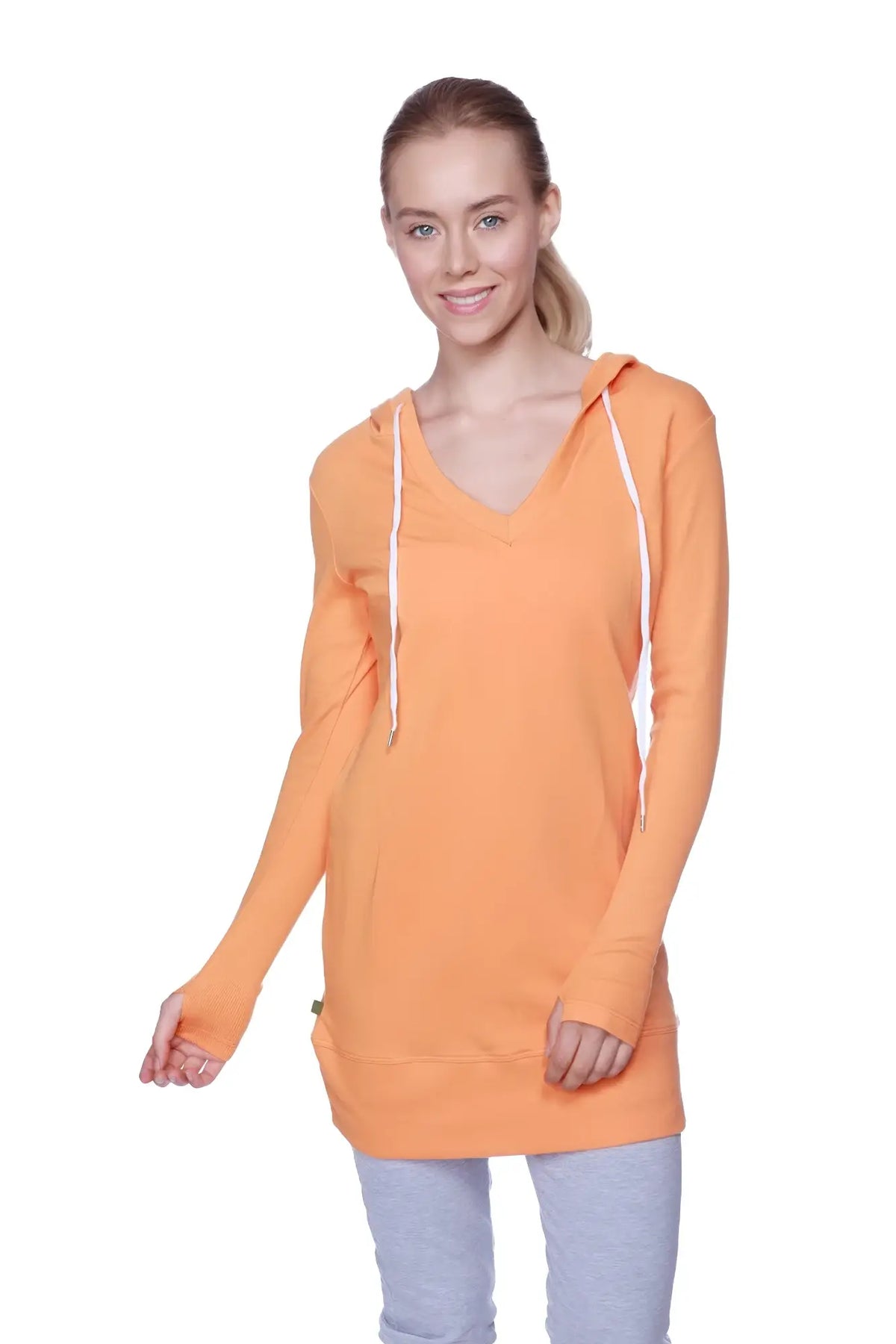 Women’s long body hoodie top in solid sun orange with white drawstrings and v-neckline perfect for casual wear