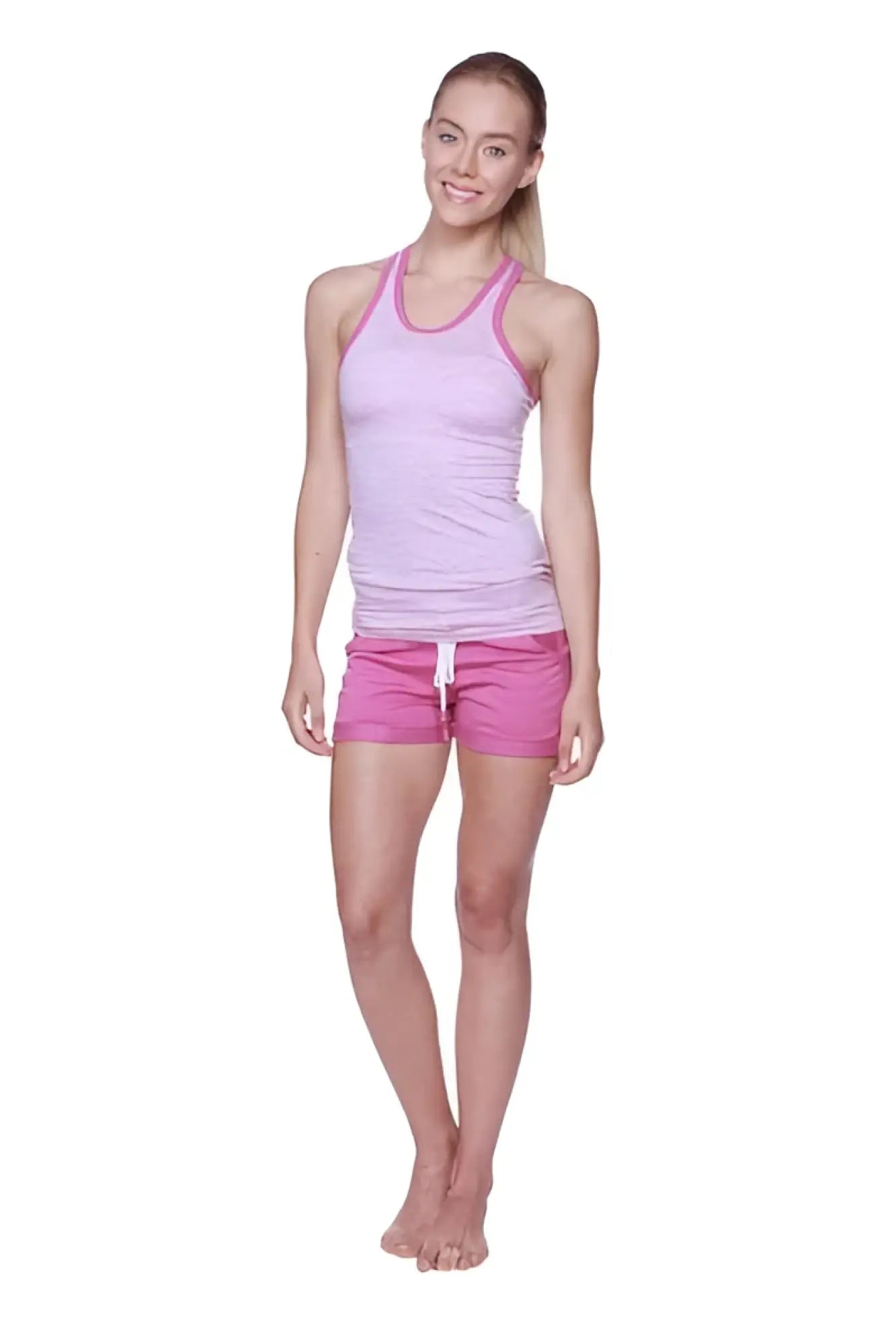A woman wearing a light pink and white striped halter tank top with bright pink women’s performance yoga shorts
