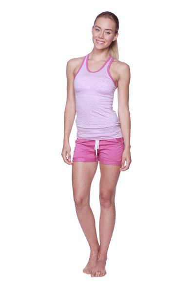 A woman wearing a light pink and white striped halter tank top with bright pink women’s performance yoga shorts