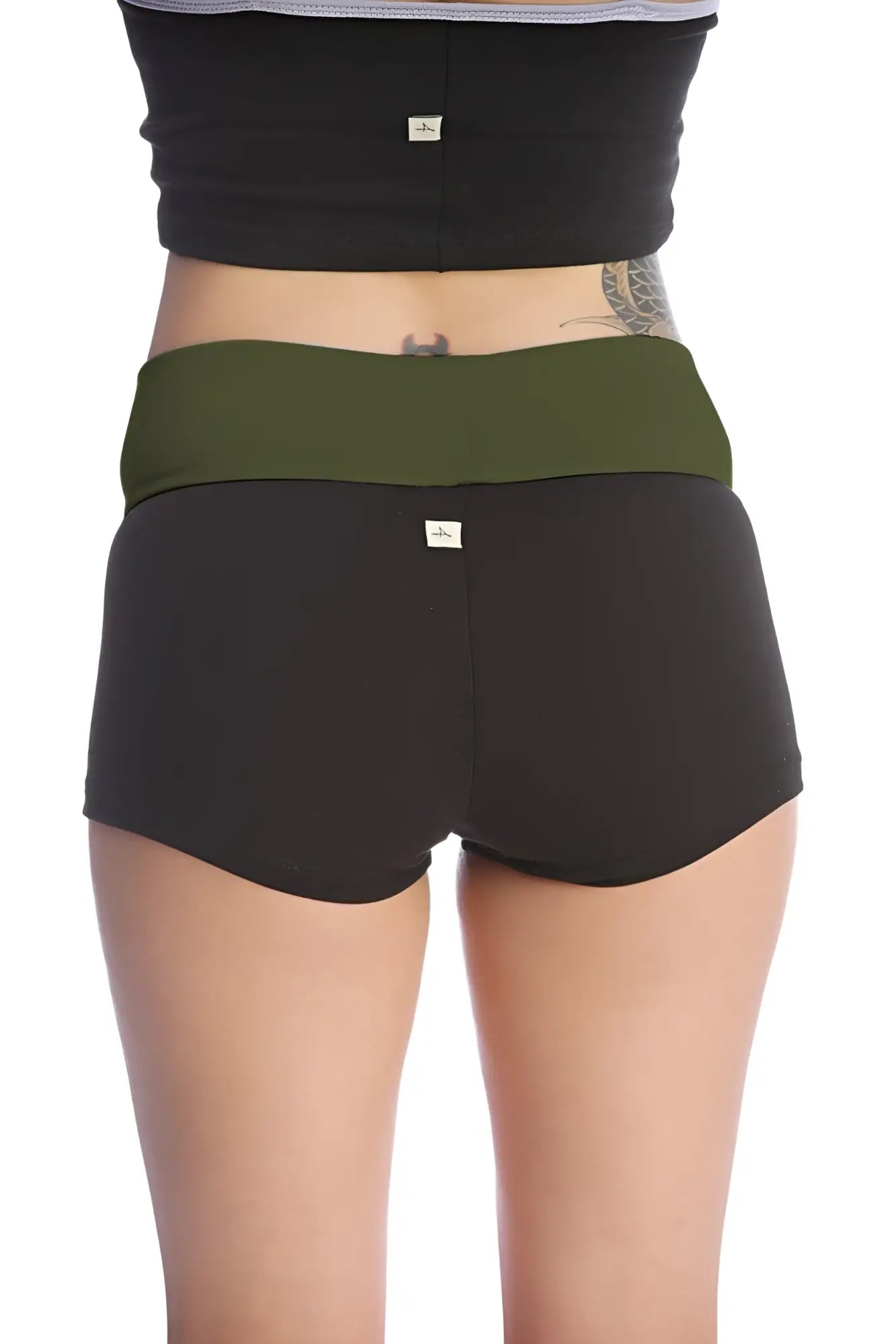 Womens yoga transition short in black with olive green waistband made of soft stretchy fabric with subtle branding