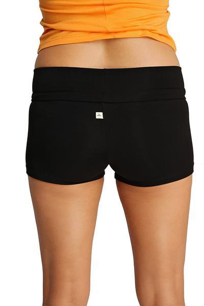 Back view of womens yoga transition shorts in black stretchy fabric with wide waistband and small white logo