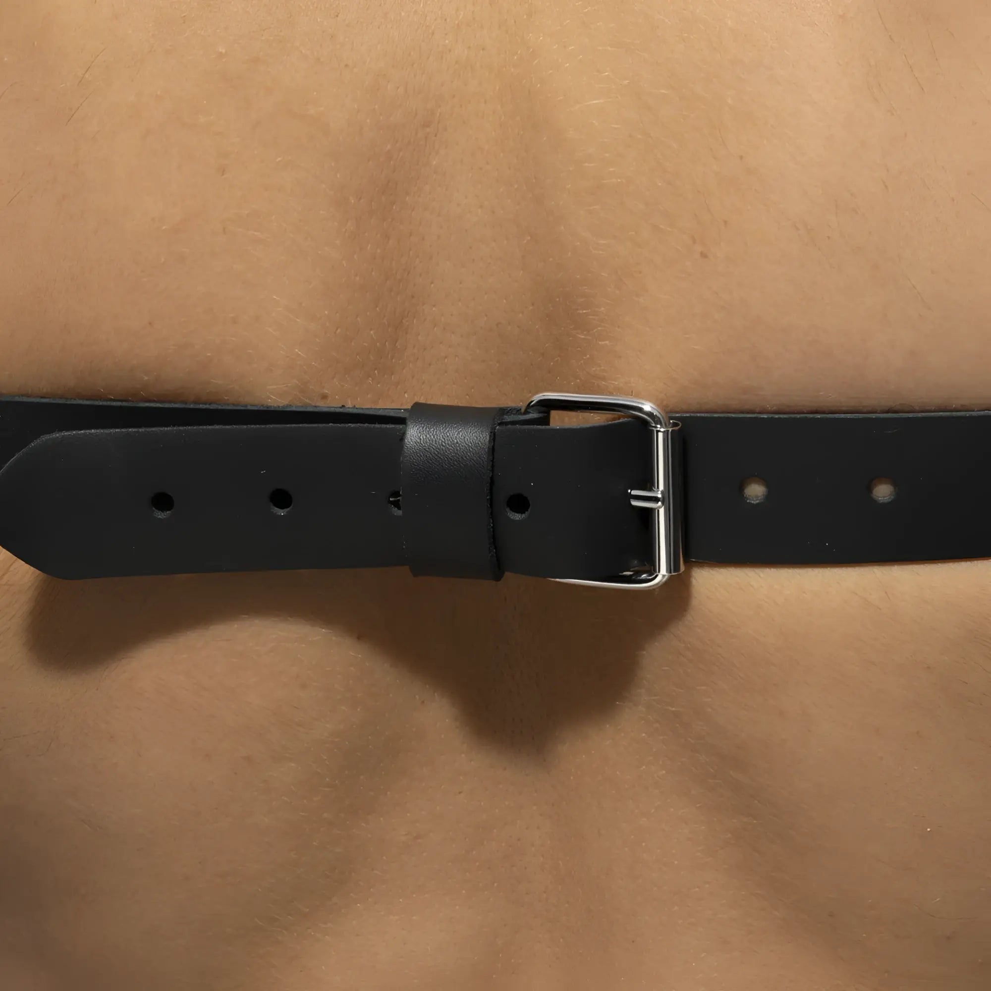 Black leather x-cross leather harness belt with silver-toned buckle designed for a secure fit and style