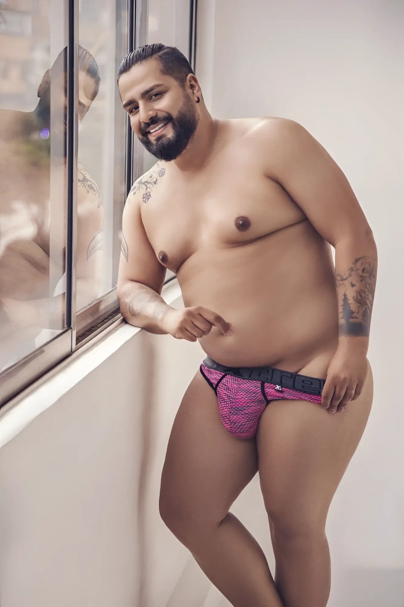 Pink xtremen 91100x microfiber mesh thong briefs with black trim and visible brand logo on waistband