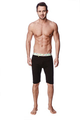 Black yoga compression short with decorative green and white patterned waistband shown from the back side