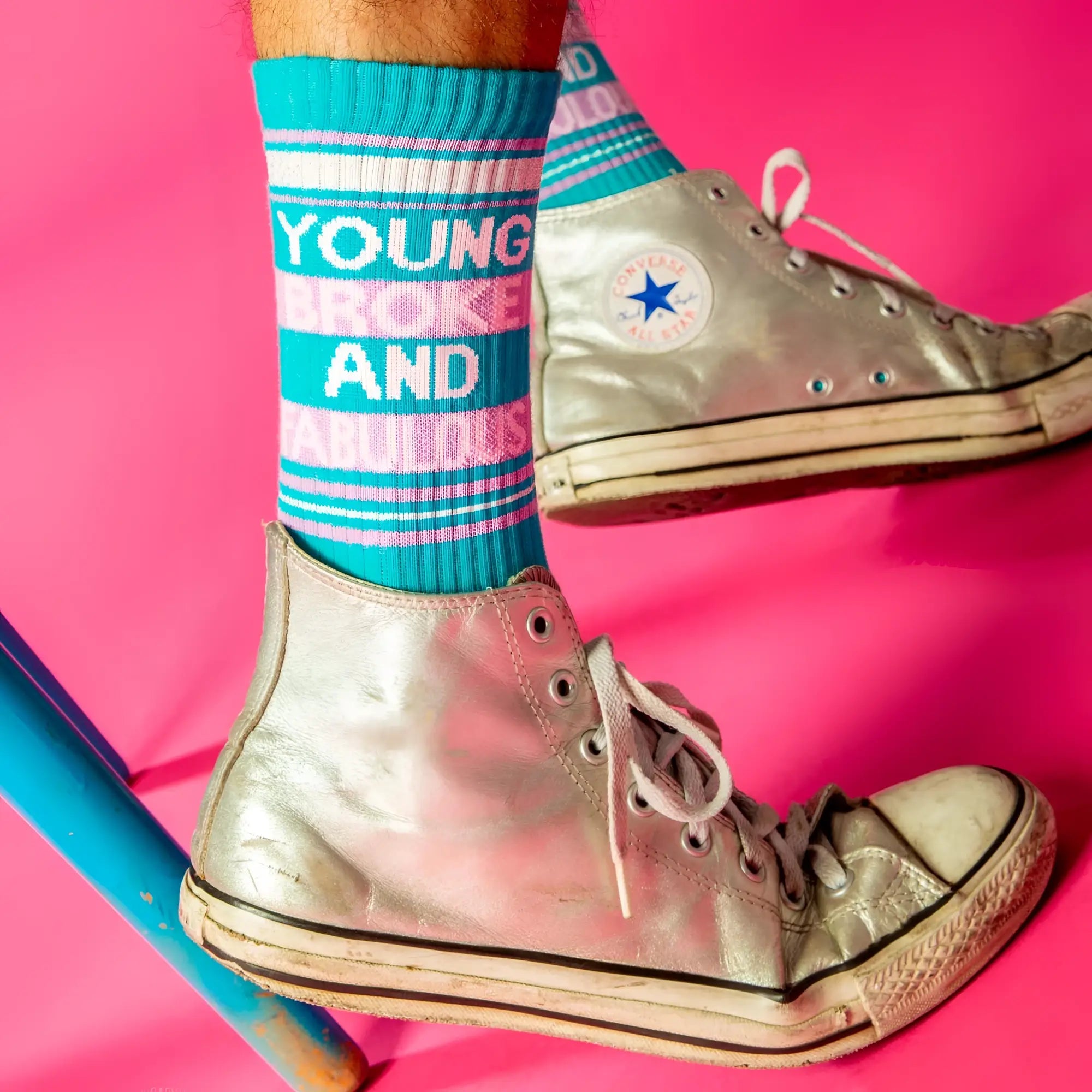 Silver high-top converse all-stars with white laces and faded rubber sole paired with young broke and fabulous crew socks