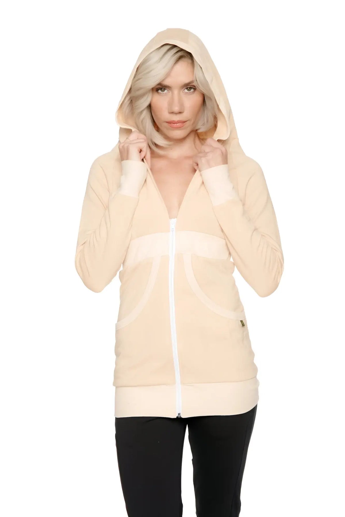Cream-colored zip-up long body travel hoodie jacket with white trim along zipper cuffs and hem in sand beige
